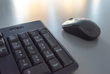 Black mouse next to keyboard