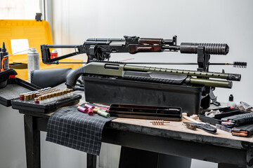 Shotgun rifle with cartridges on table in a weapon workshop