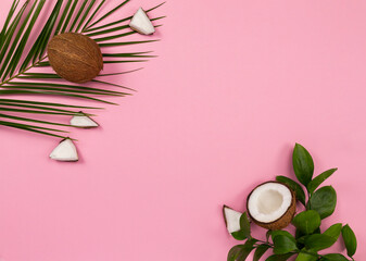 Fototapeta na wymiar coconut and leaves on pink background