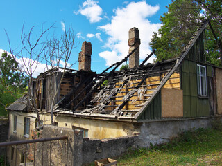 Fototapeta premium The roof of the building after the fire. The wooden roof burned down.