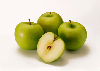 Couples green apples and halved on white background.