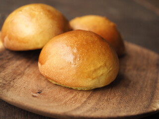 dinner rolls on wooden plate