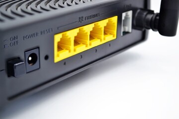 View back of a wireless router on white background,Selective focus.