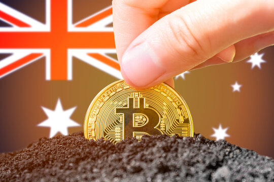 Legalization of bitcoins in Australia. Bitcoin landing in the ground against the background of the Australian flag. Australia - investment in cryptocurrency.