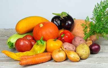 Fresh organic vegetables of different colors on a white table made of boards