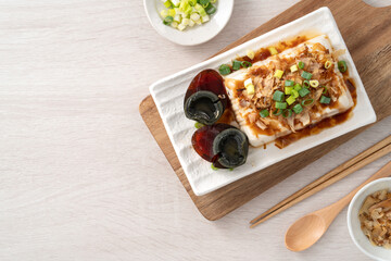 Delicious Chilled tofu and century egg with soy sauce and bonito flakes.