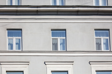Windows on the wall of an old high-rise building.
