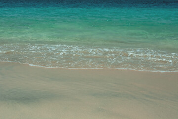Summer beach, ocean waves on a tropical sea with deep blue wawes.