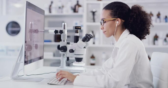 Scientist doing science research on computer online, listening to music with earphones and working in a medical lab for future innovation. Black woman doing futuristic work and investigation on web