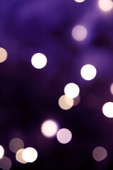 Purple festive background with bokeh lights. Christmas or New Year.