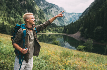 Active hiker hiking, enjoying the view, looking at mountain landscape