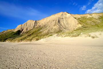 Cliff and empty beach at Ferring on the North Sea coast of Denmark in perfect evening light against...