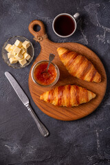 French croissant. Freshly baked croissants with jam butter coffee