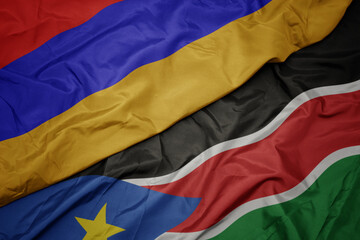 waving colorful flag of south sudan and national flag of armenia.