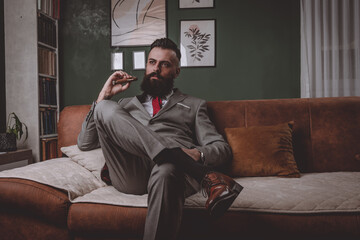 businessman in a grey suit smoking cigar