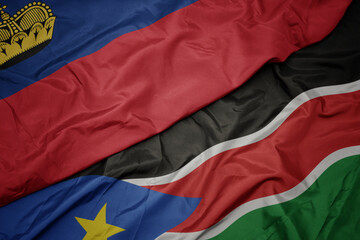 waving colorful flag of south sudan and national flag of liechtenstein.