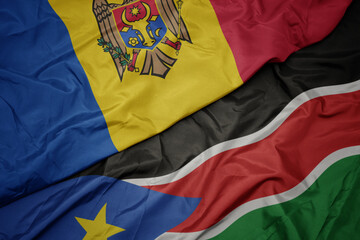 waving colorful flag of south sudan and national flag of moldova.