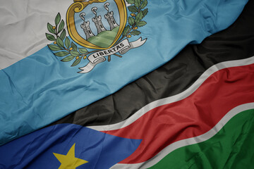 waving colorful flag of south sudan and national flag of san marino.