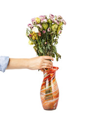 Withered bouquet of flowers in a vase isolated. A woman's hand removes a wilted bouquet of flowers.