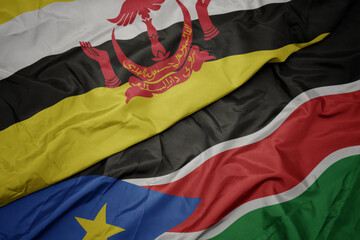 waving colorful flag of south sudan and national flag of brunei.