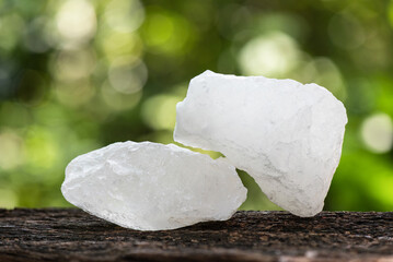 Alum crystal on bokeh nature background.