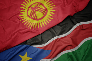 waving colorful flag of south sudan and national flag of kyrgyzstan.