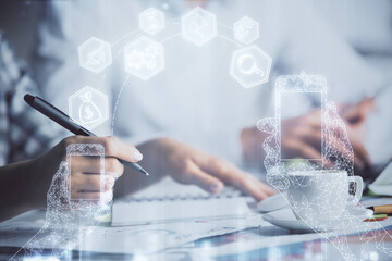 Double exposure of technology theme drawing over people taking notes background. Concept of Tech