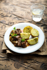 Homemade beef ragout with pickles and potato