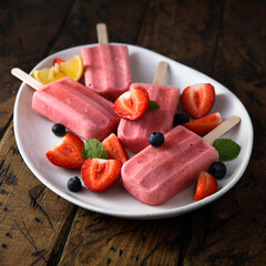 Traditional homemade berry popsicles on a plate