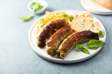 Obraz na płótnie Canvas Traditional homemade sausages with sauerkraut ragout