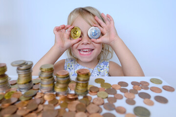 bitcoin glasses, stacks of euro currency coins, small child, blonde girl 3 years old holds bitcoin crypto currency coins in hands, financial literacy of children, Electronic decentralized money