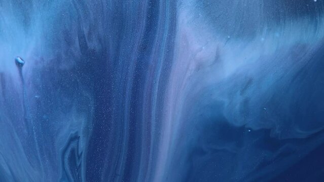 Liquid paint mixing backdrop with splash and swirl. Fluid art drawing video. Acrylic texture with colorful waves. Detailed background motion with white, blue and golden colors.