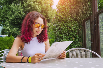 Woman reading menu and choosing dinner food and beverage in outdoor cafe and restaurant