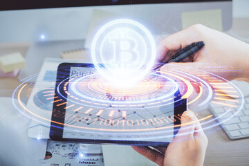 Double exposure of man's hands holding and using a phone and crypto currency blockchain theme...