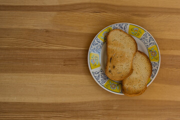 Toasts on a plate with an ornament on a wooden table