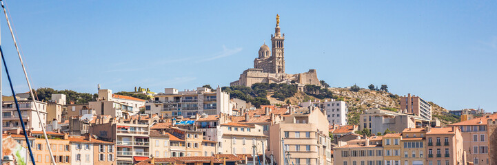 Notre-Dame de la Garde church seen from a boat sailing on the mediterranean sea in Marseille, France