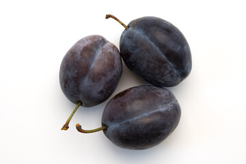 three ripe plums isolated on white background
