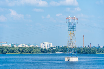 Electricity transmission towers and power lines. High voltage pole on the river. Energy concept in...