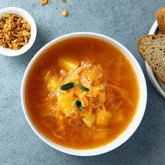 Traditional homemade sauerkraut soup with fresh parsley