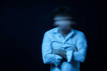 schizophrenic portrait of man with mental disorders and mental illnesses in straitjacket on dark background