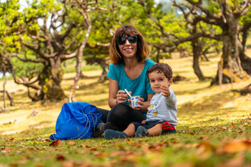 Fanal forest in Madeira, feeding him a yogurt between laurel trees in summer
