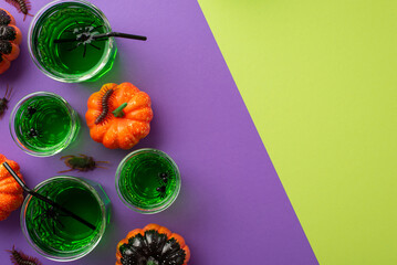 Halloween night concept. Top view photo of green drink with floating spiders and straws in glasses...