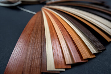 Samples of laminate and vinyl tiles on wooden background isolated.