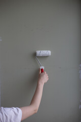 painting a wall with roller