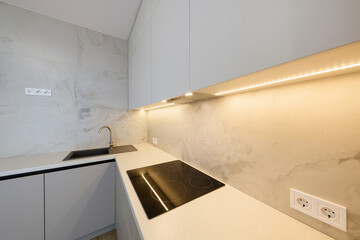 Interior design of a new kitchen with stylish furniture. Cleanliness and order