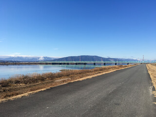 Jogging track with blue sky,river ,mountain and bridge