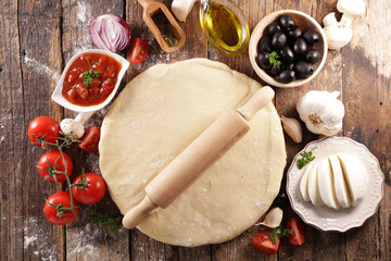raw dough pizza and ingredients