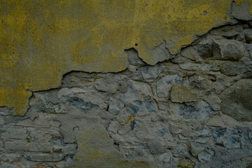 old wall background partly yellow and partly brick closeup. Textured stone. Copy space. 	
