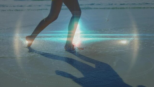 Animation of light spots over caucasian woman at beach