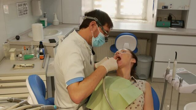 Dental clinic. Young adult woman at the dentist appointment.